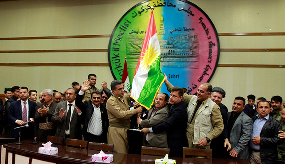 Kurdish parties raise the Kurdish flag at the Kirkuk Governorate Council in Kirkuk